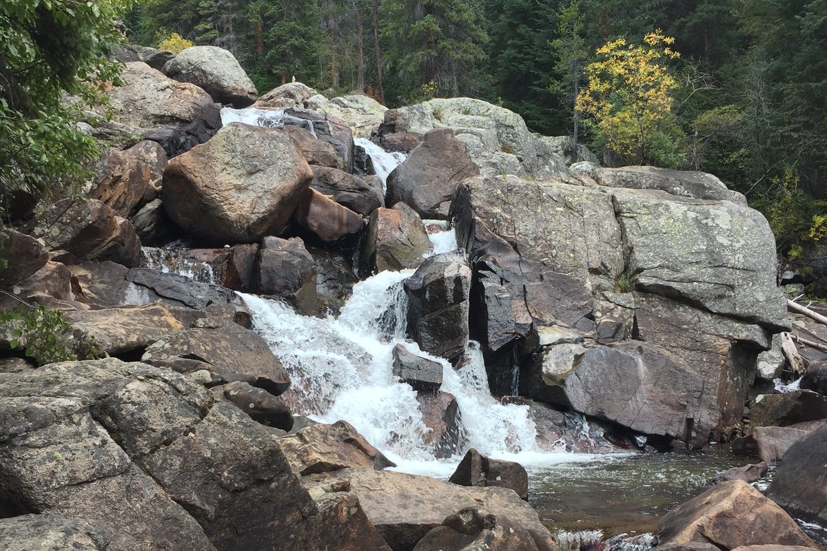 Cascade Falls tumbling over granite boulders in Rocky Mountain National Park