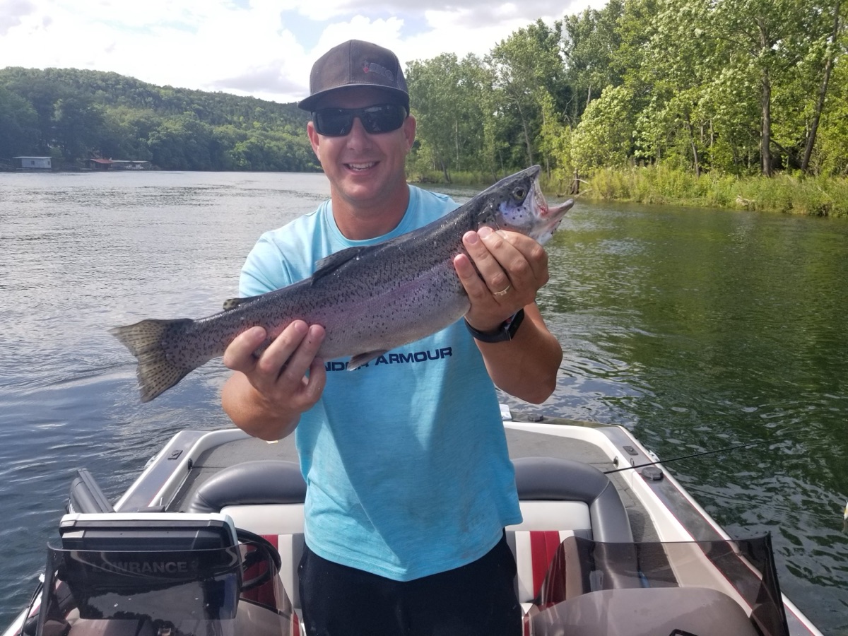 Angler holding a trout on Table Rock Lake